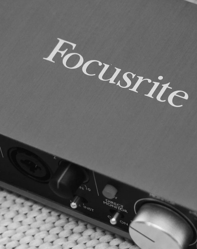 Someone using a focustrite interface on a desk.