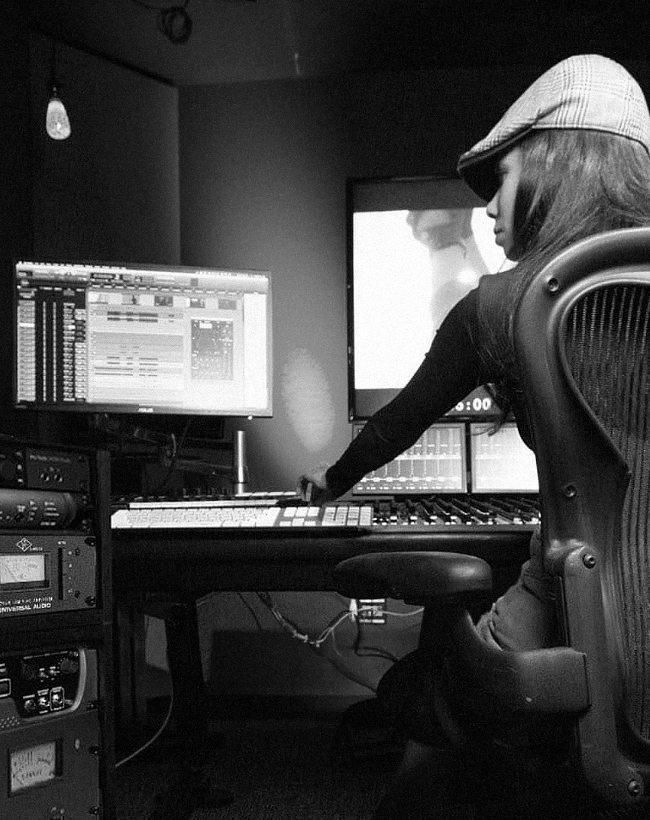 Woman in recording studio using ProTools