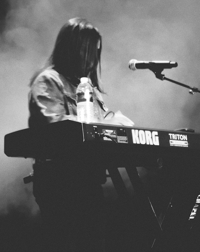 Musician on stage playing Kork keyboard.
