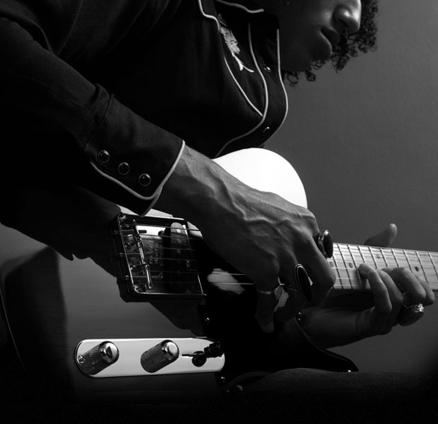 Man playing Fender Jaguar electric guitar