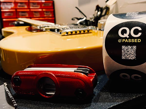 Red Gibson electric guitar lying face up on workbench with tools