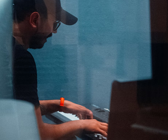 candid photo of a man playing a keyboard