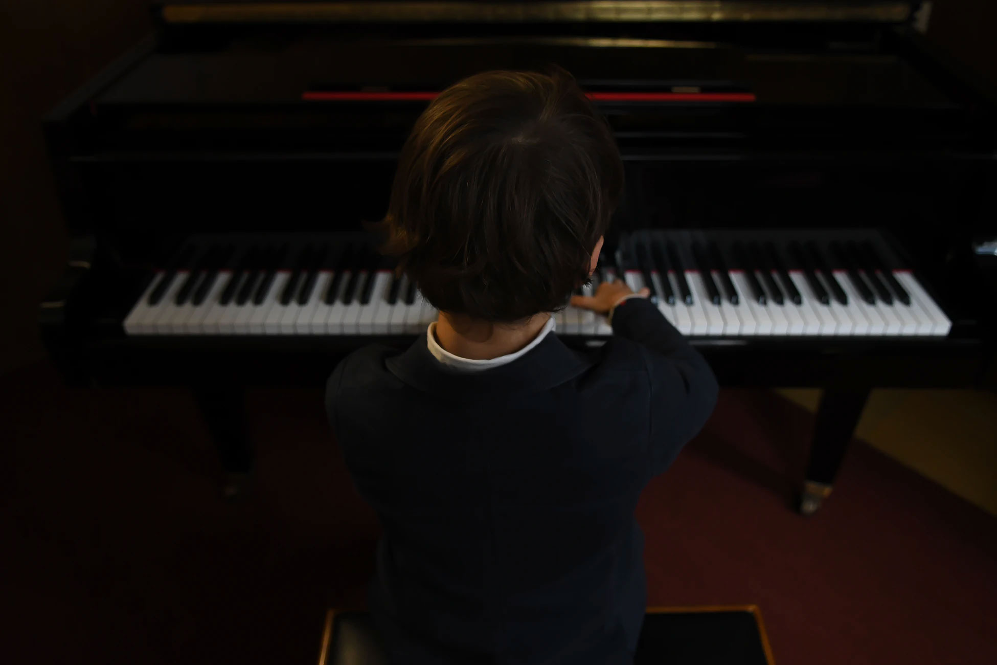 Kid sitting at a piano